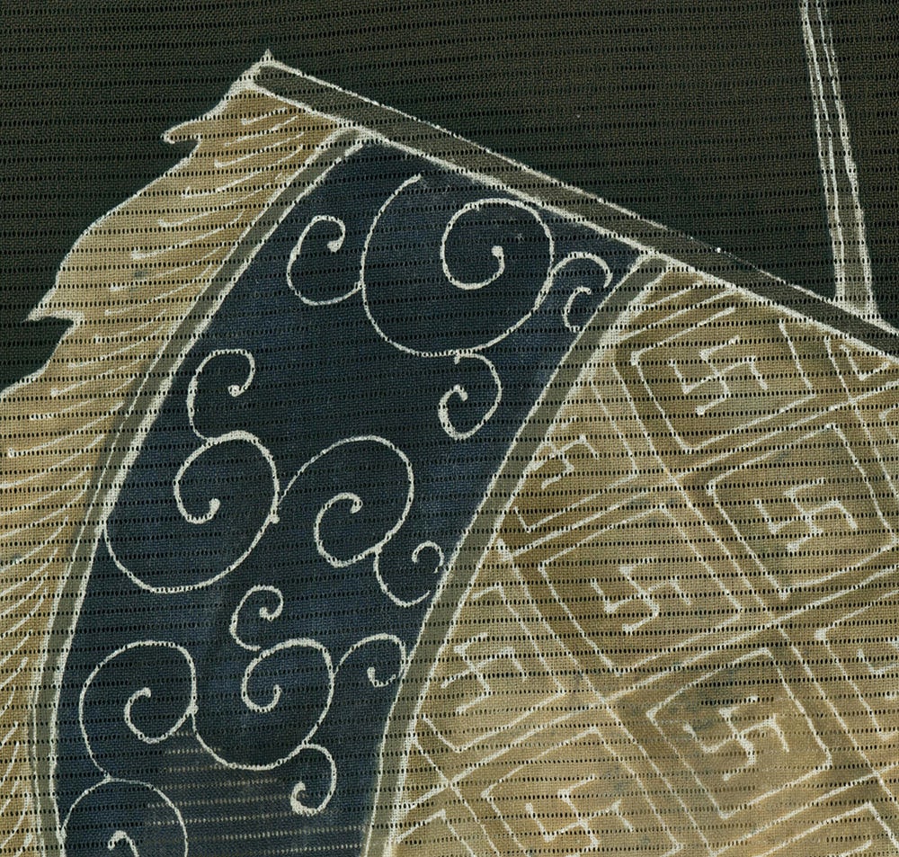 Traditional Japanese fabric with intricate dark swirling pattern on textured background