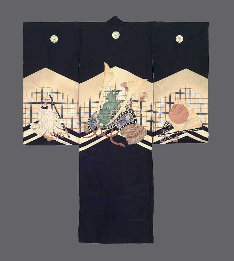 Black Japanese kimono with decorative traditional objects on light background
