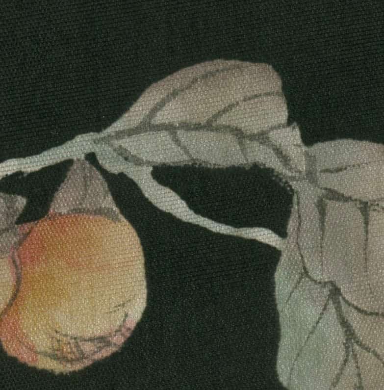 Ripe peach hanging from a branch with textured leaves