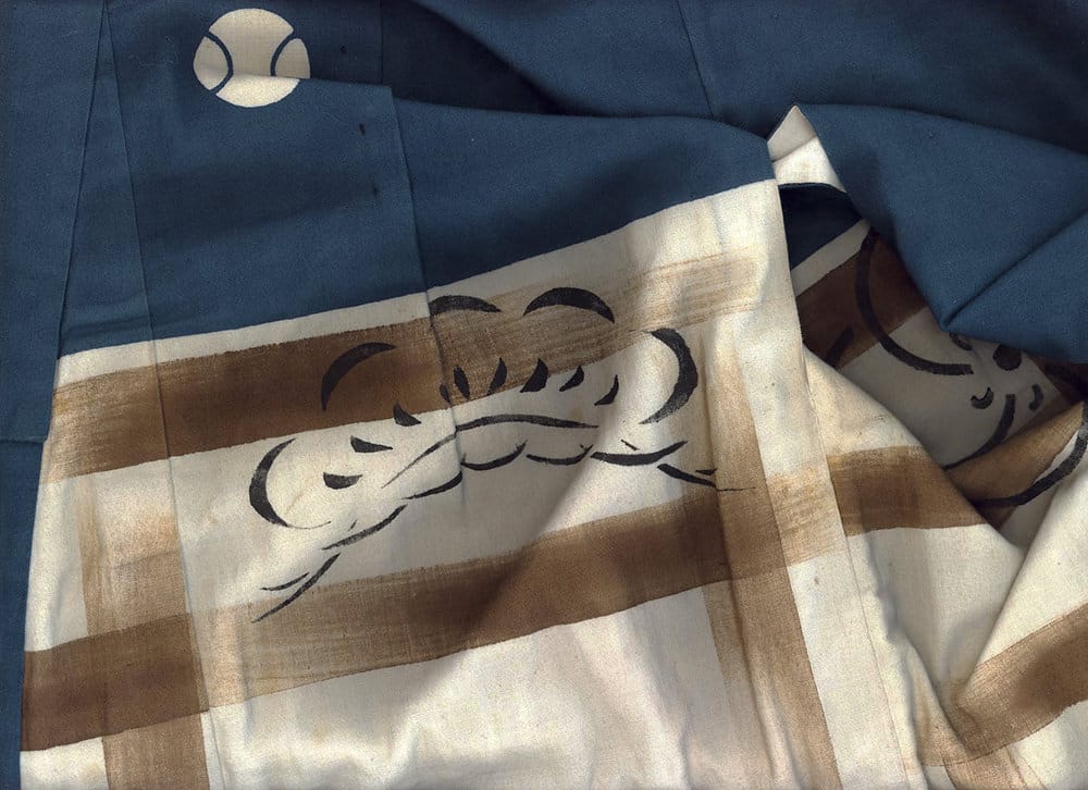 Stylized tennis ball and hand-drawn leaping animal on fabric