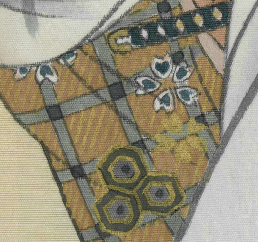Geometric textile detail with yellow, gray, and blue butterfly-like pattern