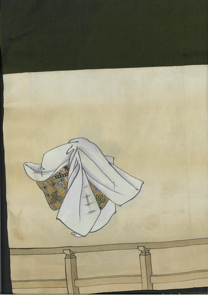 White cloth with patterned fabric draped over a simple wooden stand