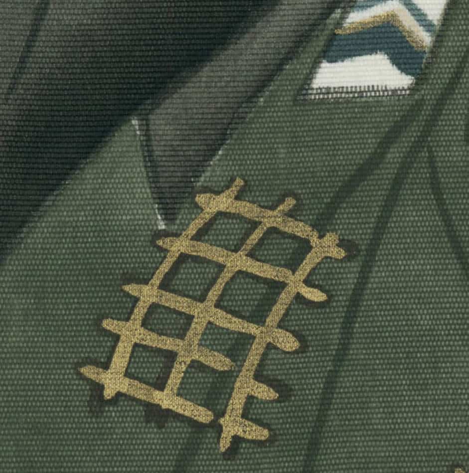 Golden grid pattern embroidered on dark green textured fabric