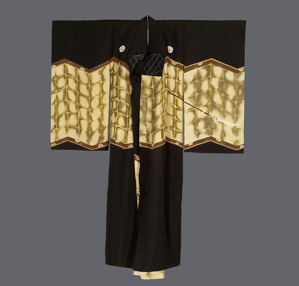 Black and gold Japanese kimono with geometric pattern displayed flat