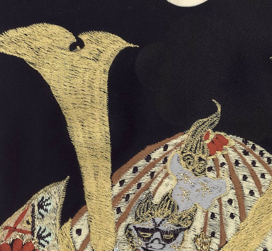 Intricate gold and black embroidered Japanese samurai armor detail