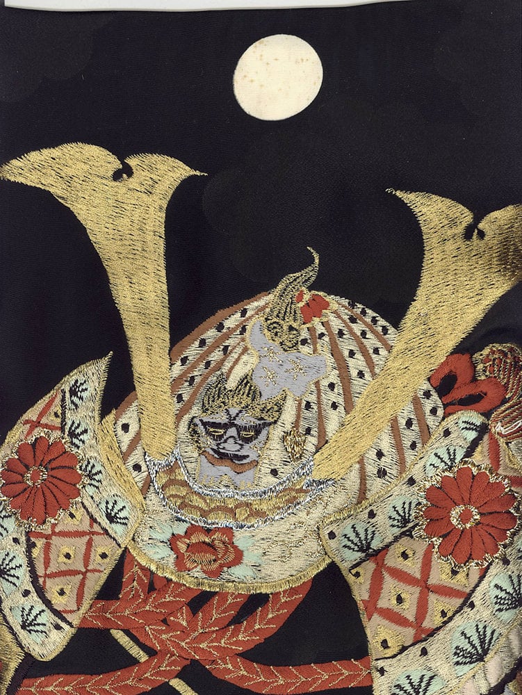 Intricate Japanese embroidery of samurai helmet under full moon