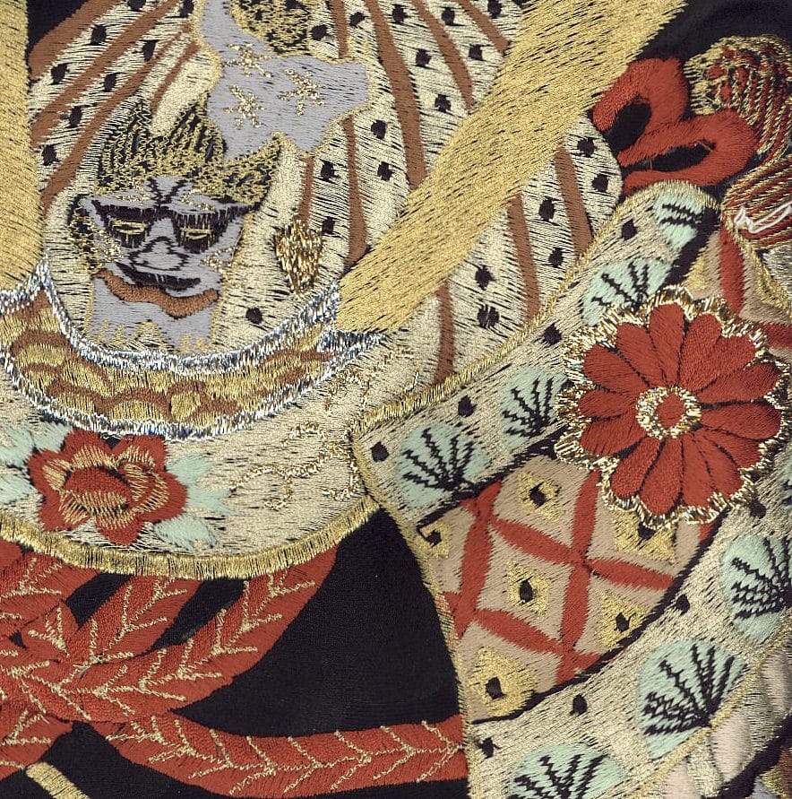 Intricate embroidered textile with gold, red, and floral patterns