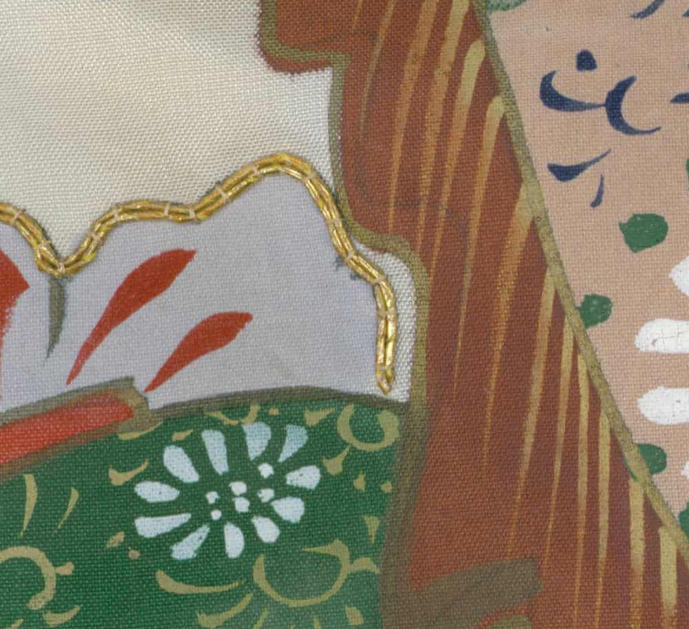 Fabric detail with embroidered gold thread, floral pattern, and rustic colors