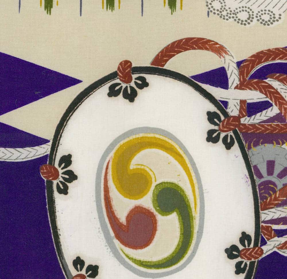 Traditional Japanese textile with tomoe symbol and floral decorative pattern