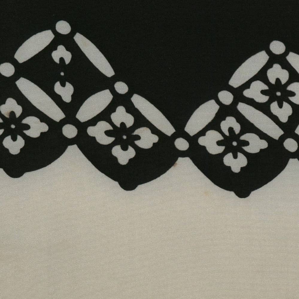 Black and white lace-like pattern with geometric floral motifs