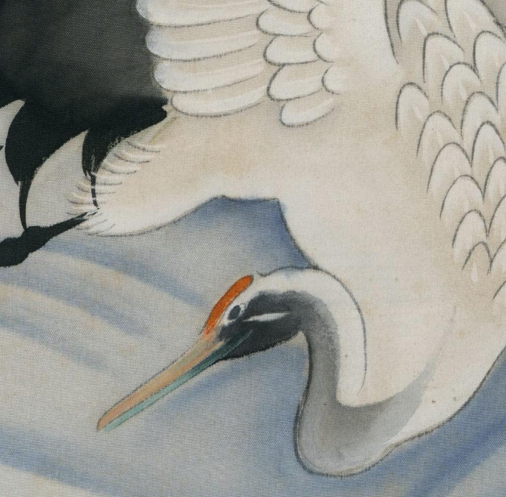 White crane with curved neck against blue and white background