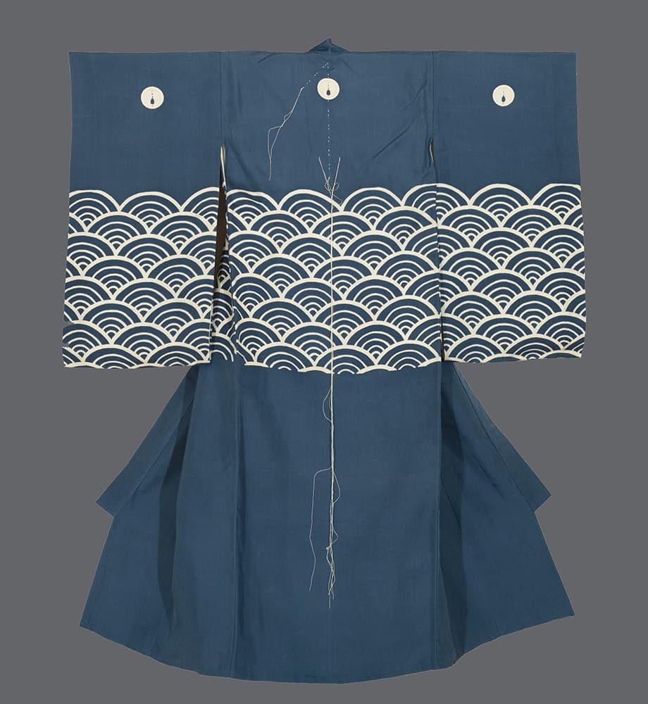 Blue Japanese kimono with white wave pattern and decorative buttons