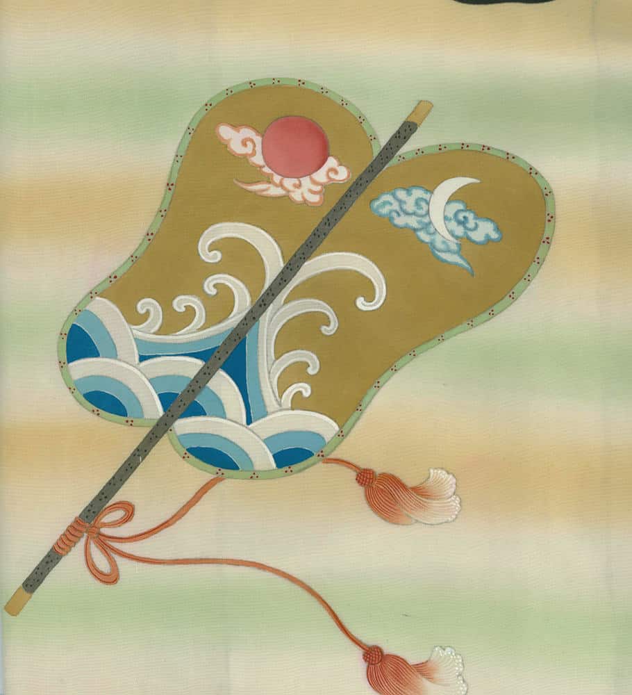 Traditional Japanese folding fan with sun, moon, waves, and decorative tassels
