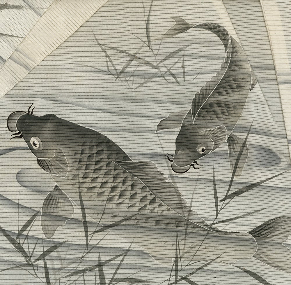 Two koi fish swimming among bamboo leaves in black and white