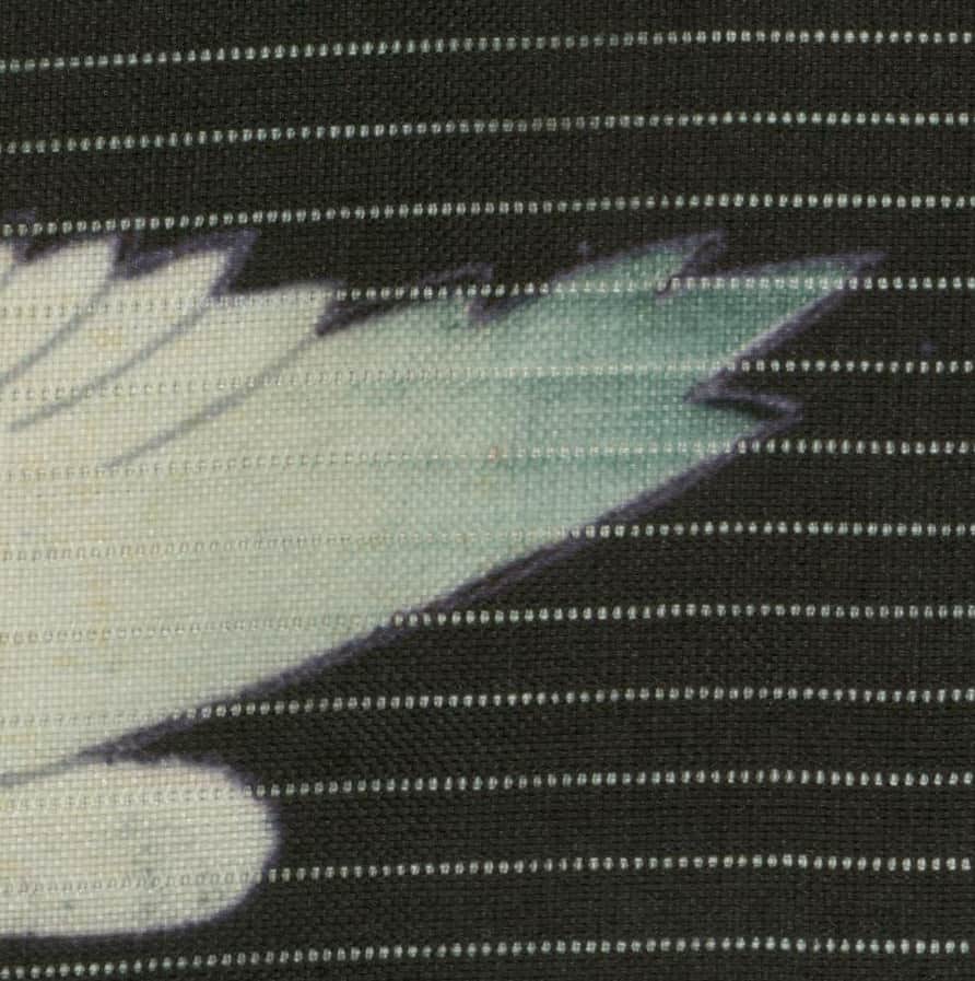 Tie-dye fabric with green, white, and black blended zigzag pattern