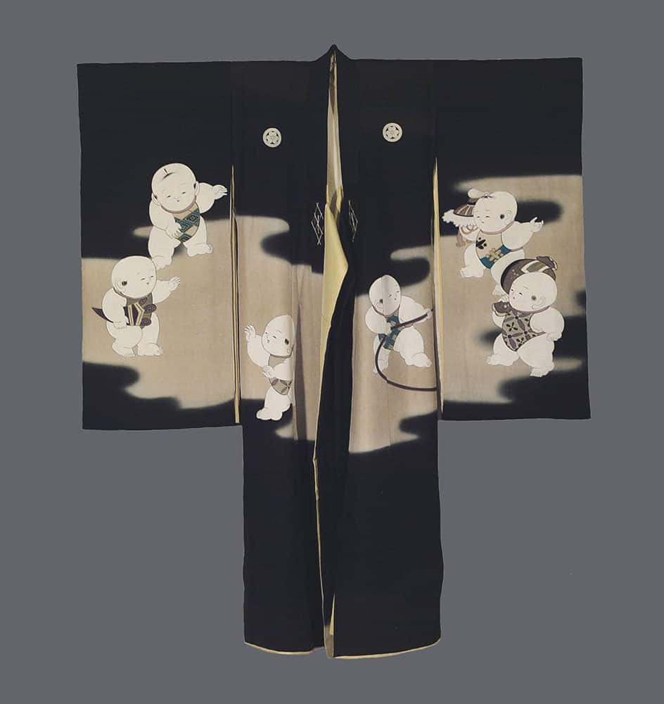 Black kimono with playful white cartoon-like characters on gold background