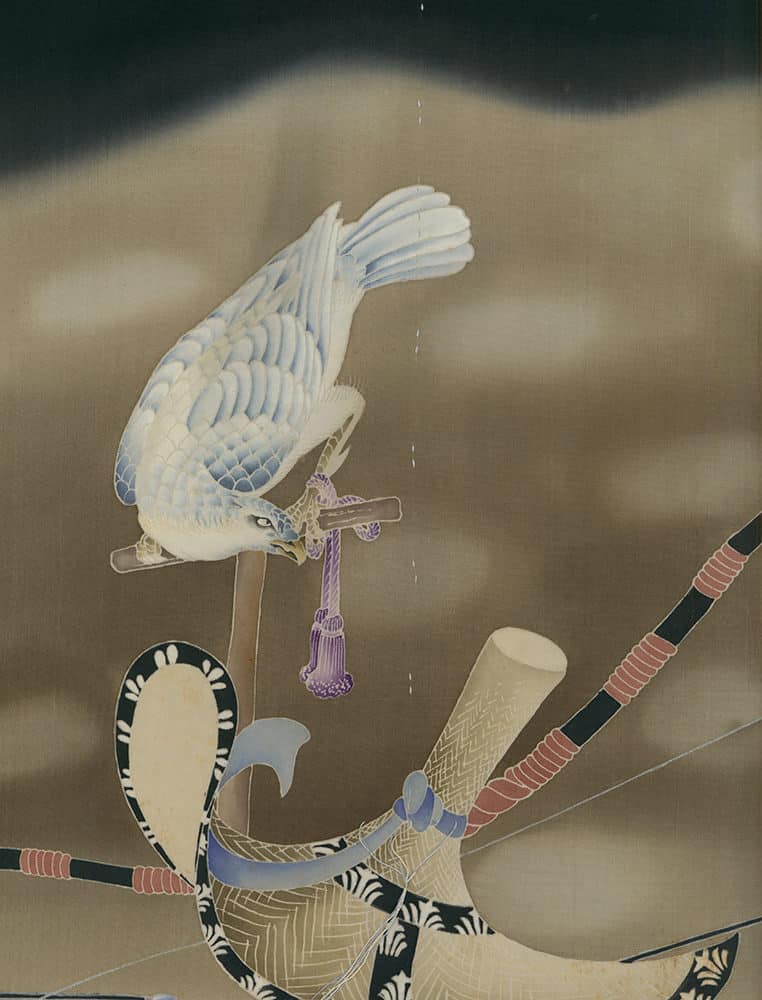 White bird perched on ornate Japanese falconry equipment