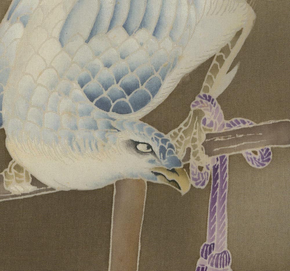 Detailed blue and white bird perched on purple branch