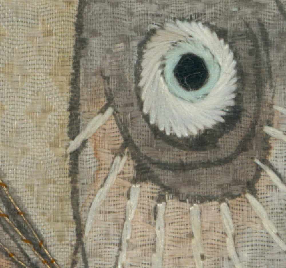 Abstract spider-like creature with white circular eye on textured background