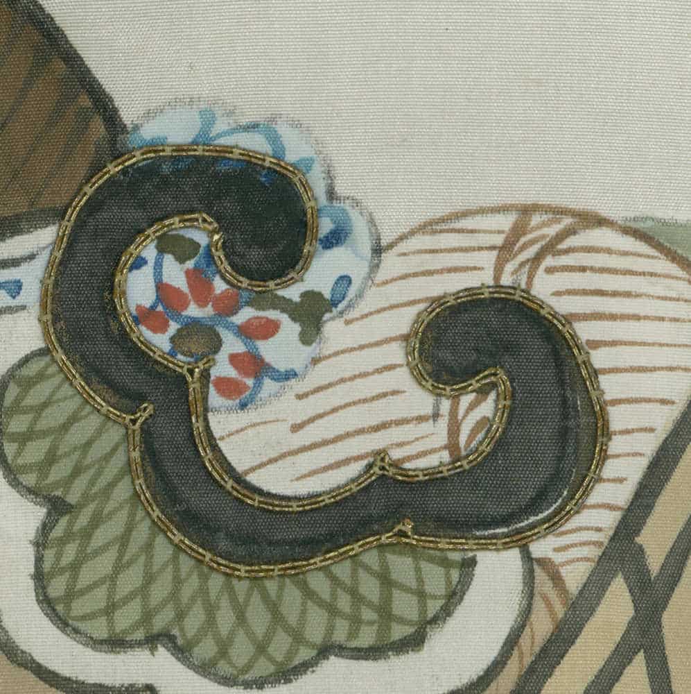 Decorative swirling embroidered design with floral motif on textured fabric