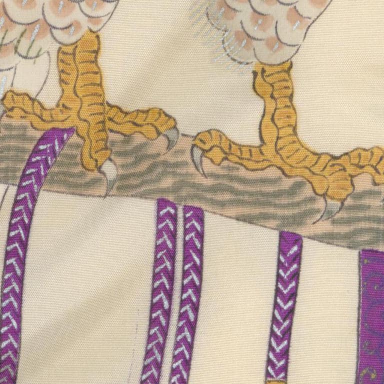 Yellow bird feet on branch with purple decorative pattern