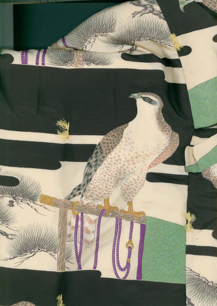 Japanese artwork of a detailed falcon perched on a decorative stand