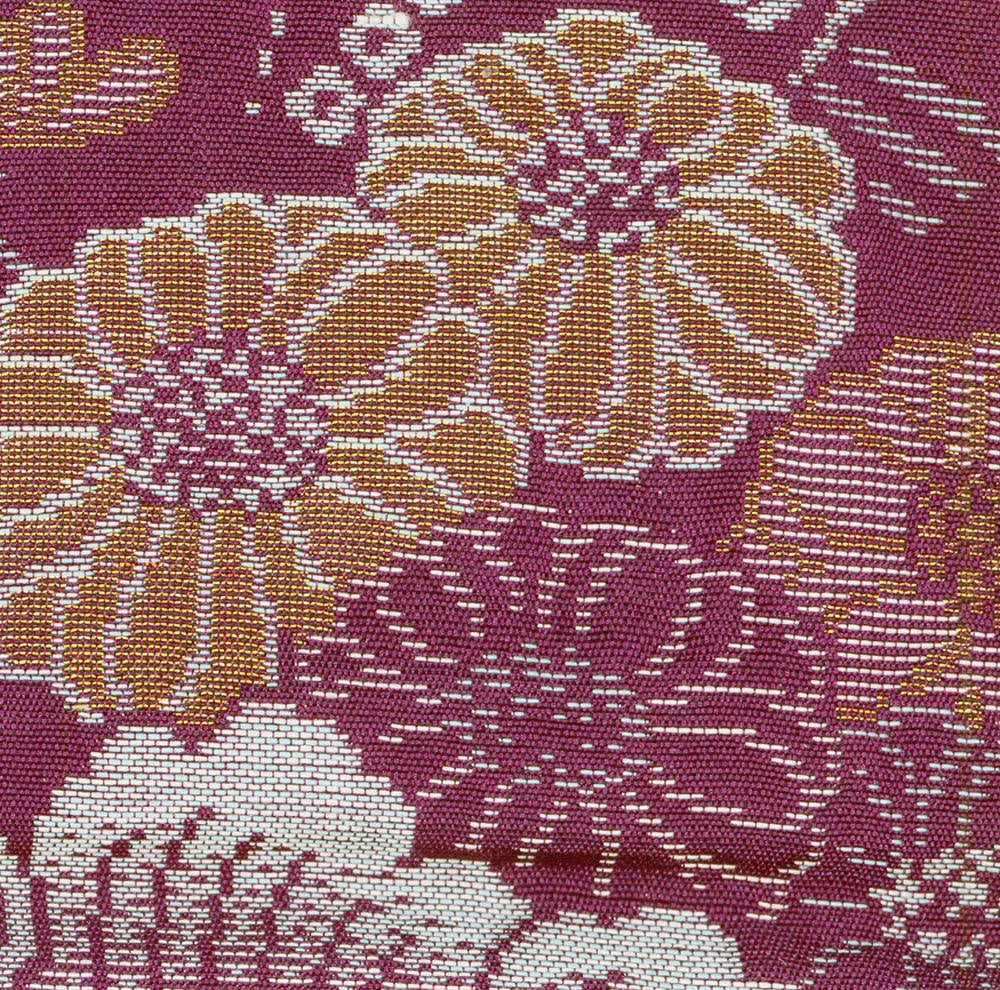Intricate floral tapestry with burgundy, gold, and white woven pattern