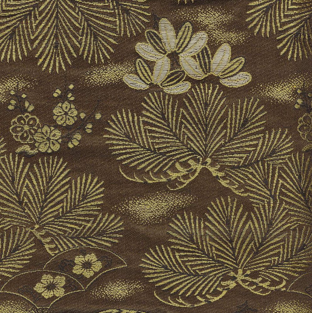 Vintage fabric with golden botanical pattern of leaves and flowers