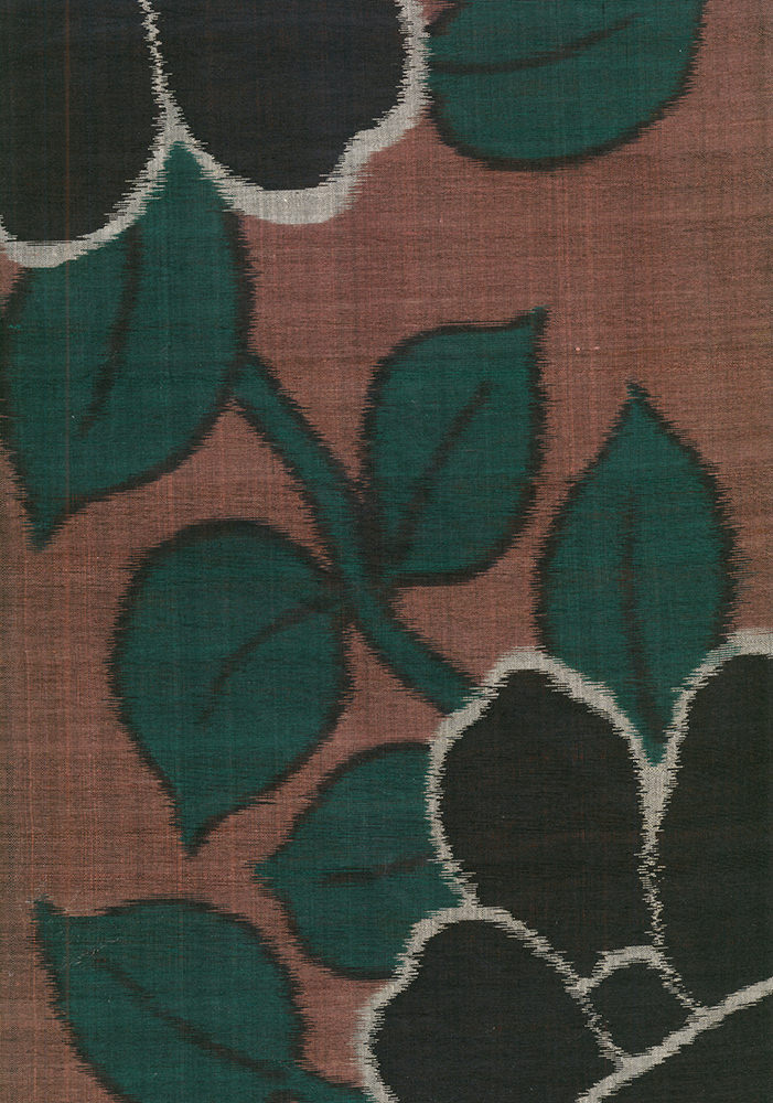 Vintage textile with abstract green leaf pattern on rusty red background