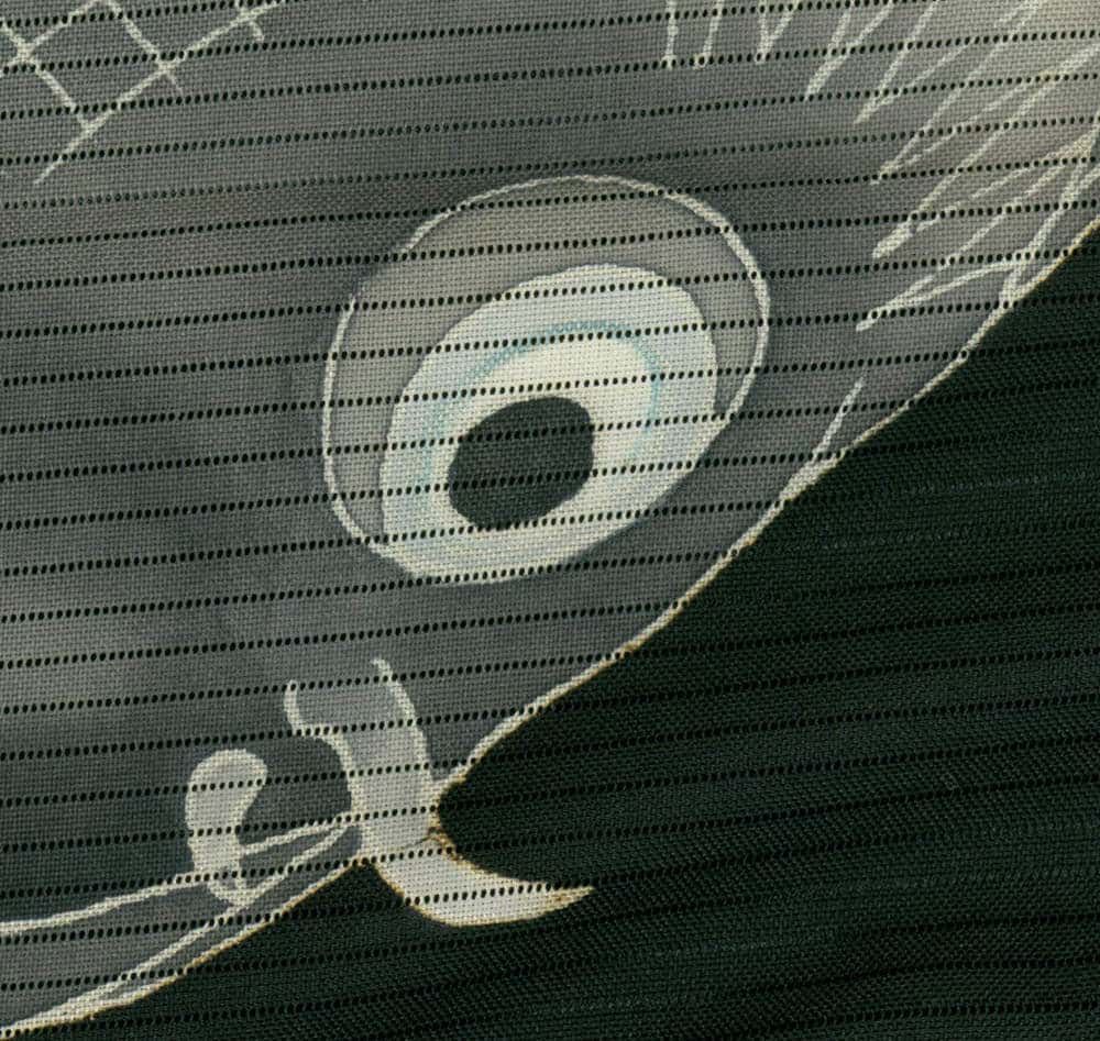 Textured fabric with circular and geometric dotted pattern in grey tones