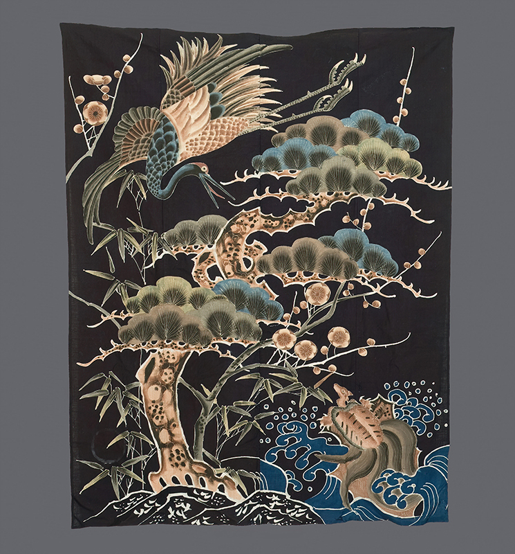 Japanese textile with crane, leopard, and pine trees against dark background
