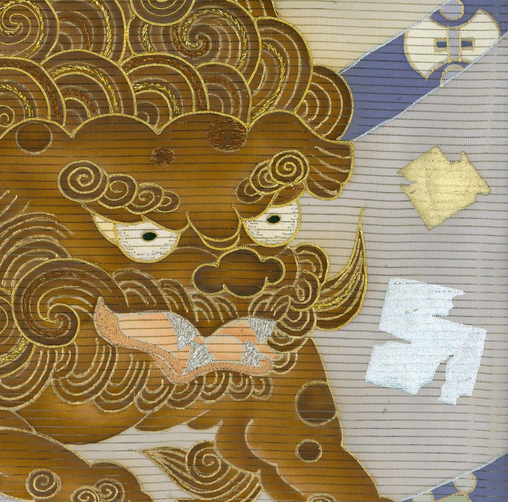 Golden intricate mask with swirling patterns on textured background