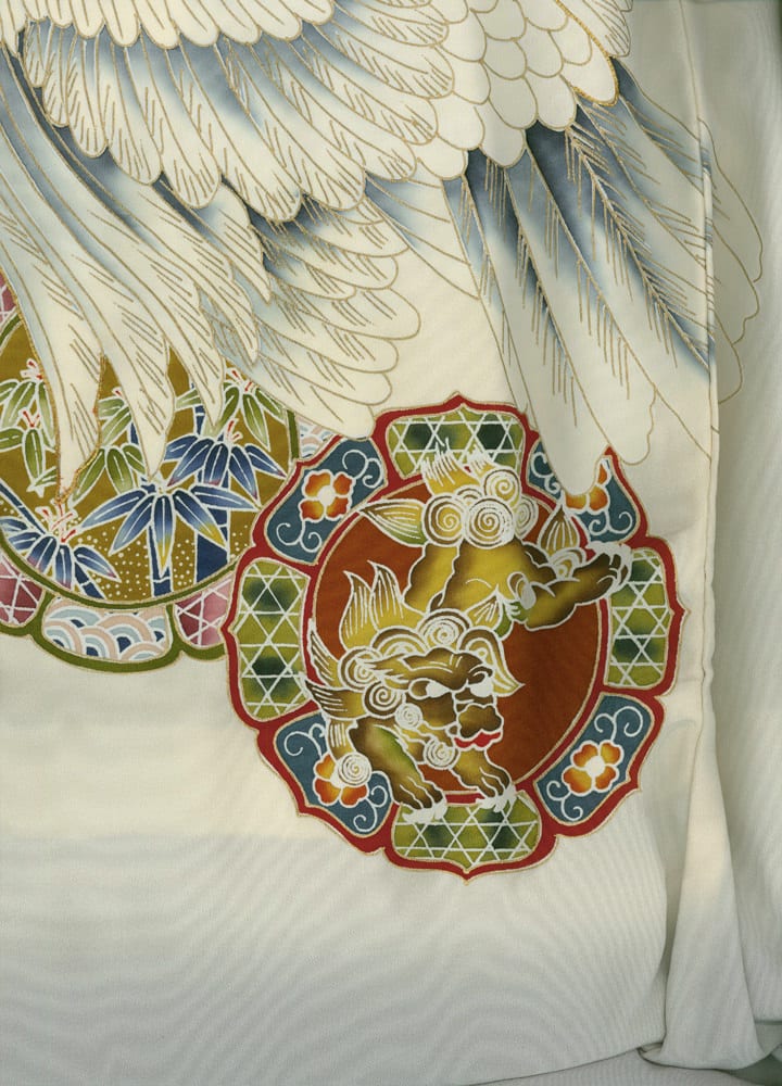 Detailed Japanese textile with white feathers and colorful mythical lion emblem
