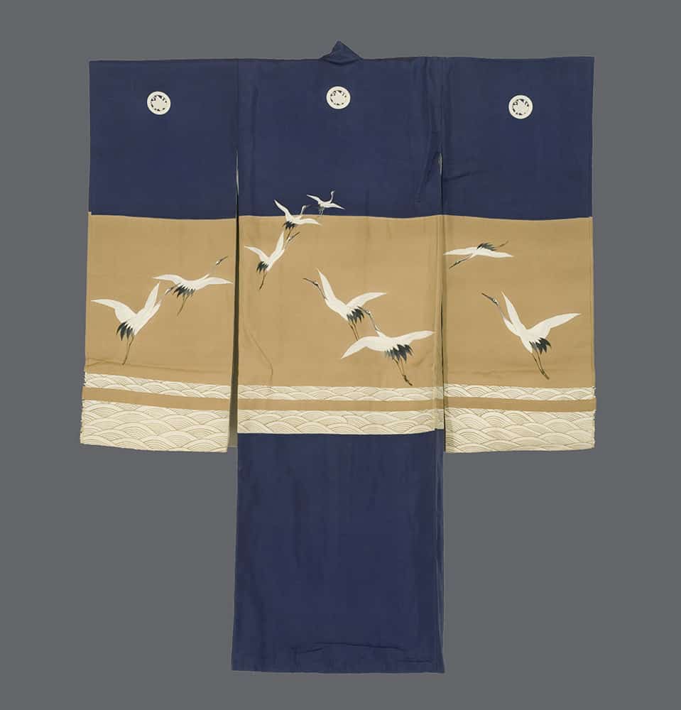 Traditional Japanese kimono with cranes flying on navy and tan background