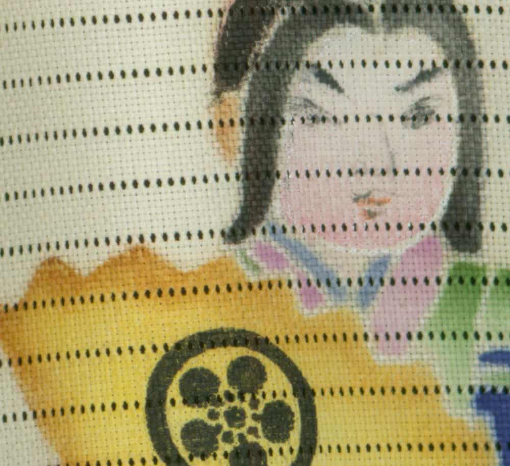 Embroidered artwork of stylized figure with floral or circular pattern