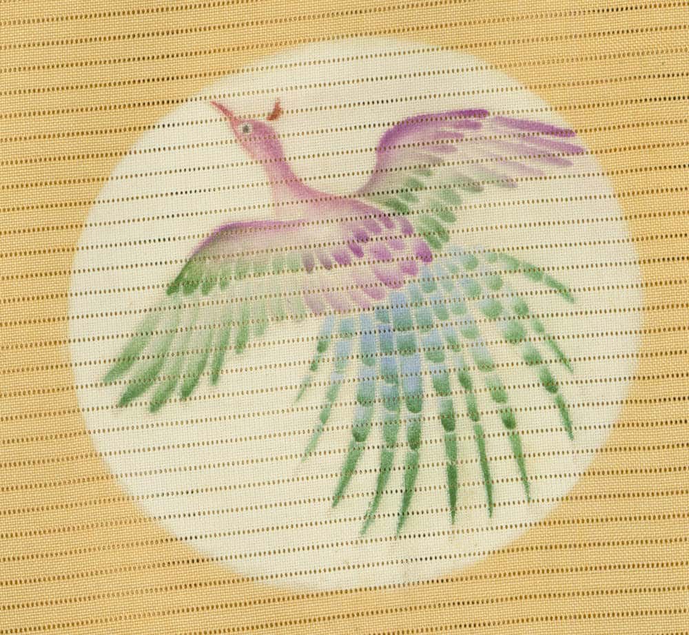 Colorful mythical bird with spread wings on textured fabric background