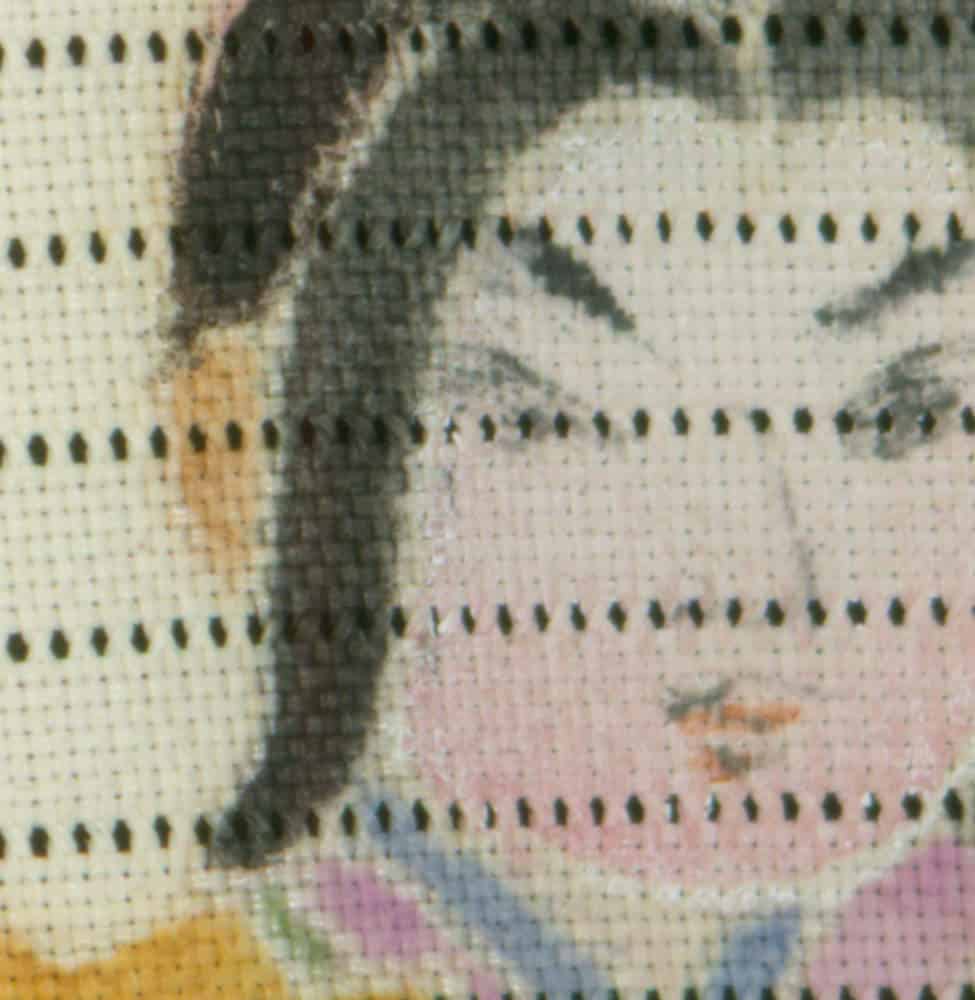 Detailed cross-stitch embroidery with pastel colors and intricate pattern