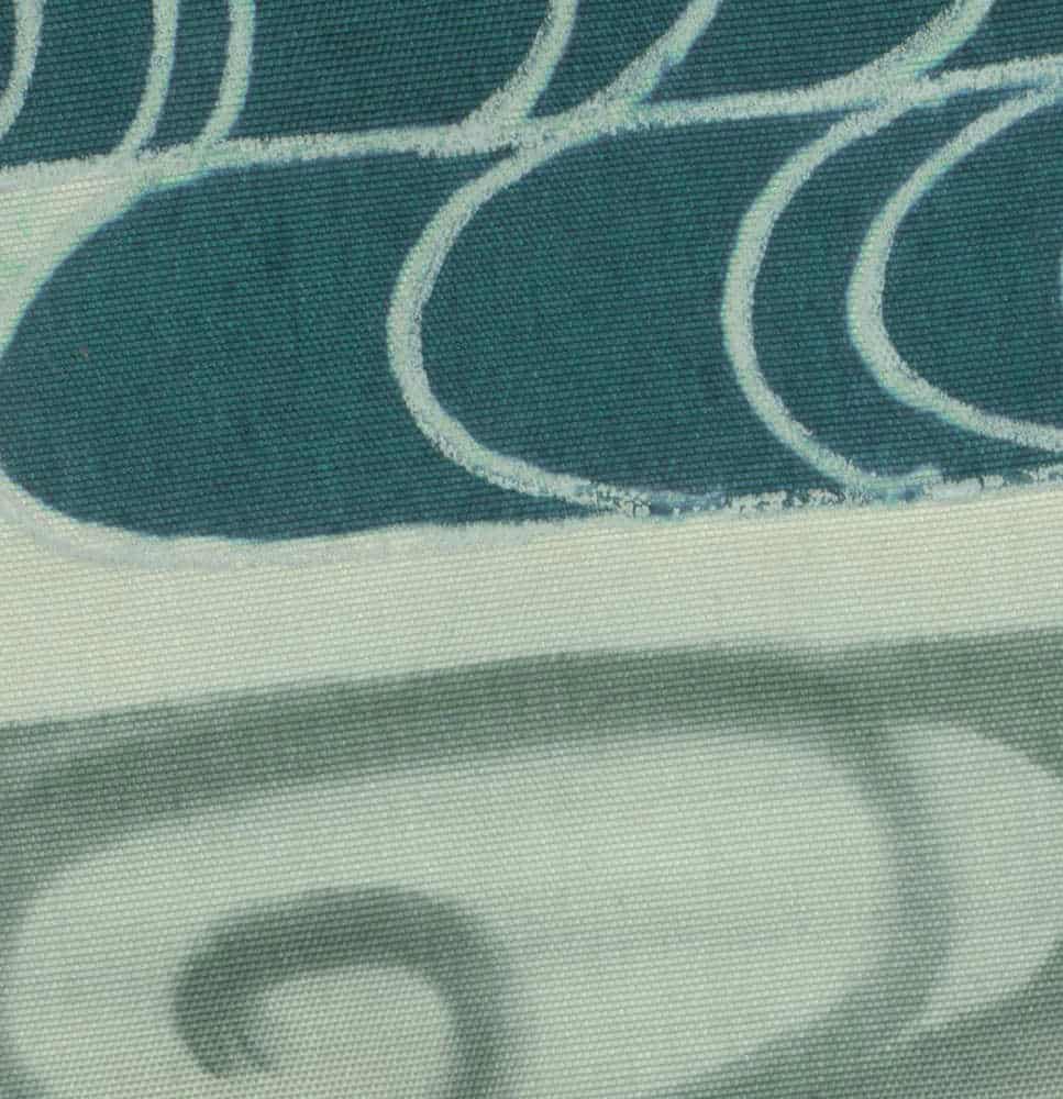 Textured green fabric with curved white lines and soft shadows