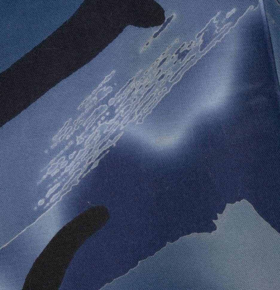 Abstract blue fabric with textured pattern and shadowy silhouettes