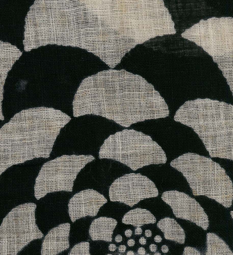 Black and white textured fabric with abstract floral or lotus pattern