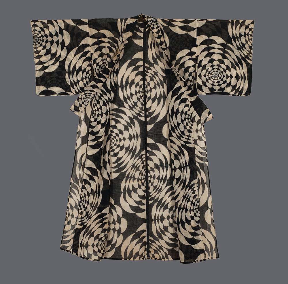 Black and white optical illusion kimono with swirling geometric pattern