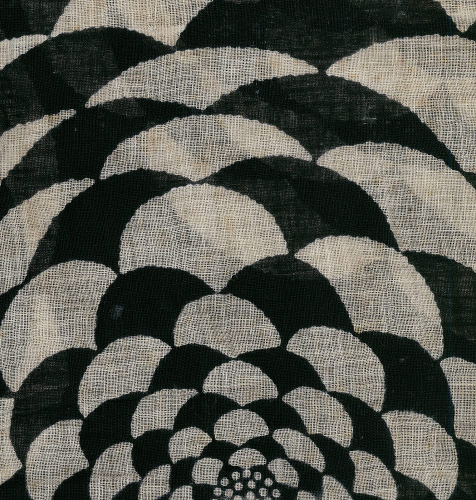 Black and white floral textile with curved pattern on textured fabric