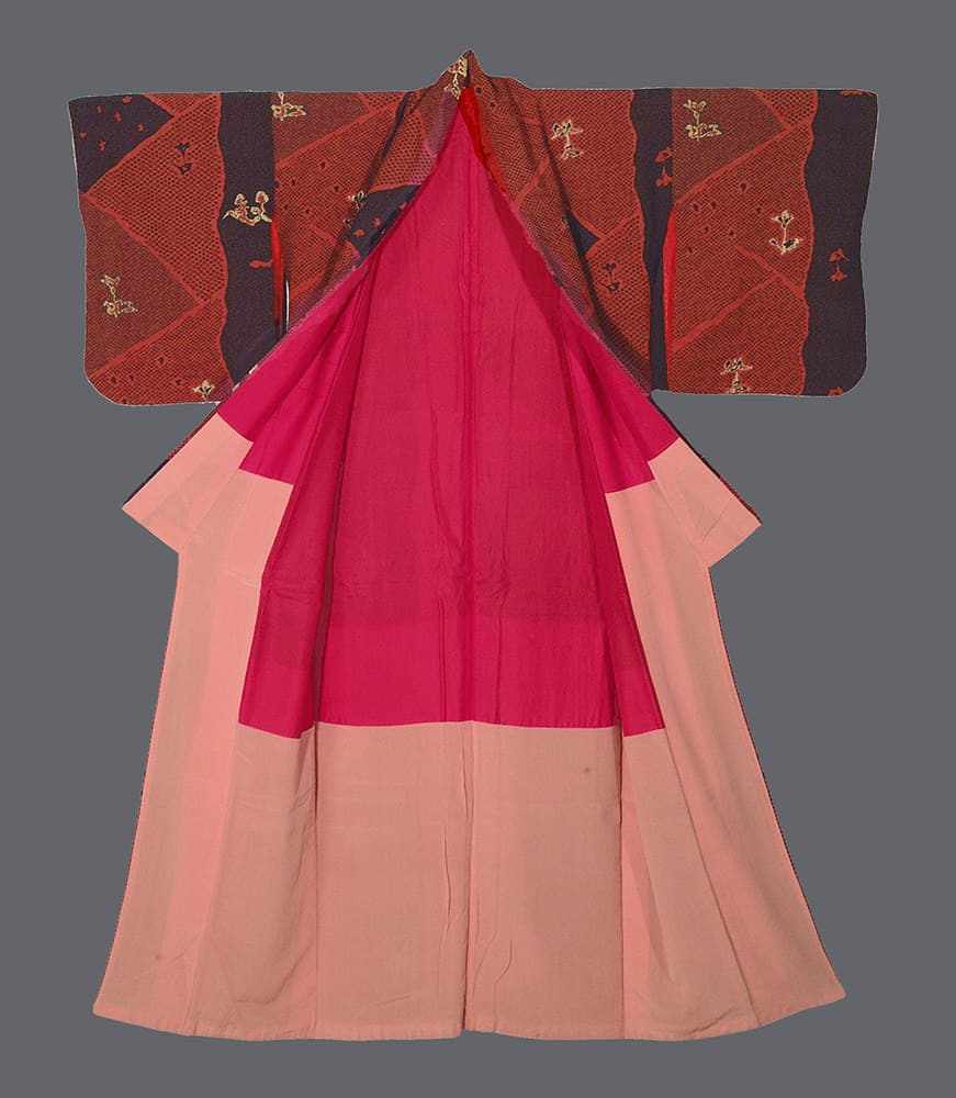 Traditional Japanese kimono in pink and red with decorative geometric patterns