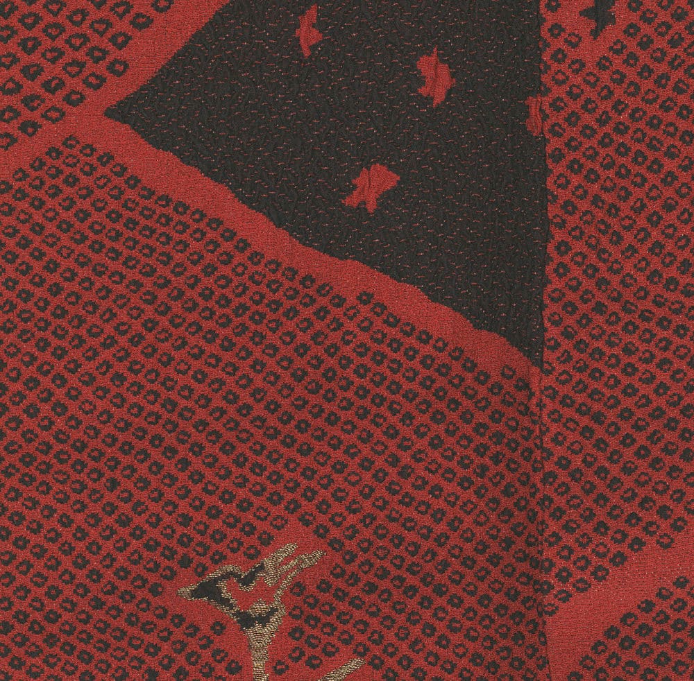 Red and black textured fabric with raised fist symbol