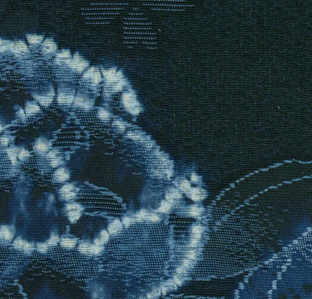 Indigo blue shibori fabric with intricate tie-dye pattern