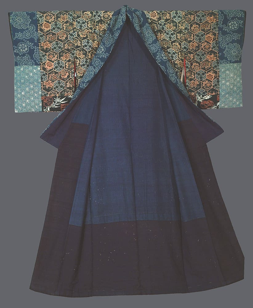 Traditional Japanese kimono with intricate floral pattern on dark blue fabric