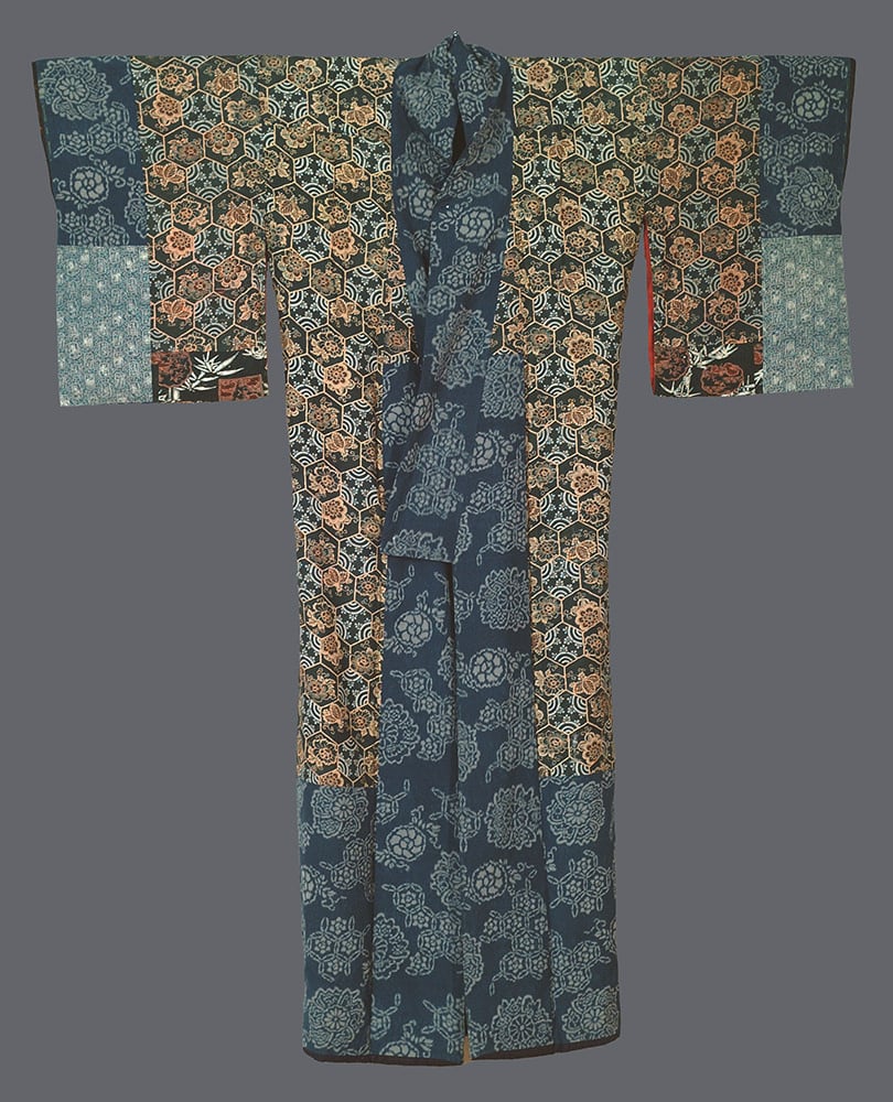 Intricate Japanese kimono with blue, orange, and floral hexagonal patterns