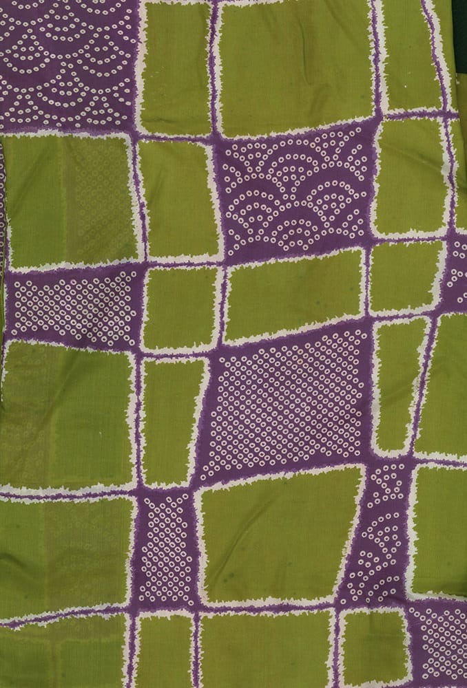Green and purple geometric textile with circular dot pattern