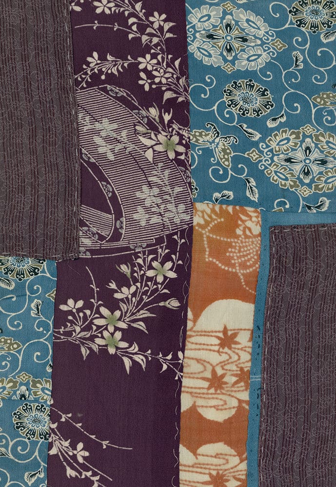 Patchwork textile with floral patterns in purple, blue, and orange colors