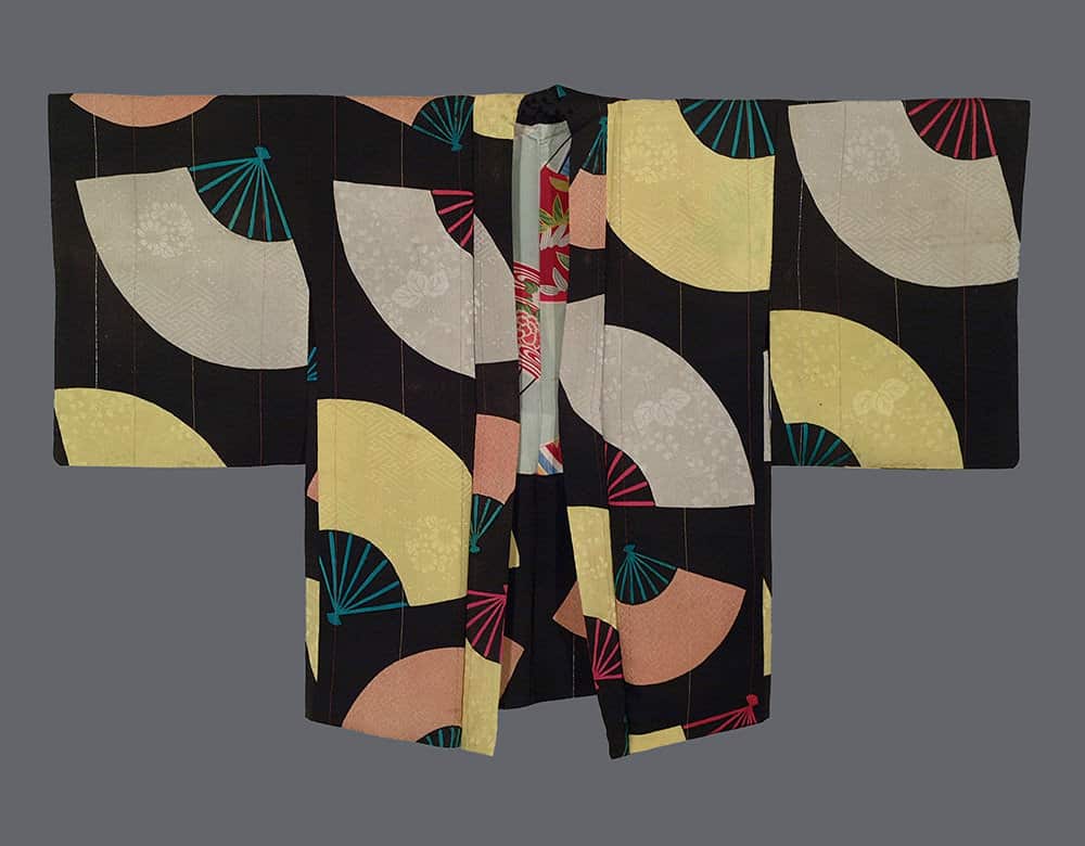 Vintage Japanese kimono with geometric fan pattern in black background
